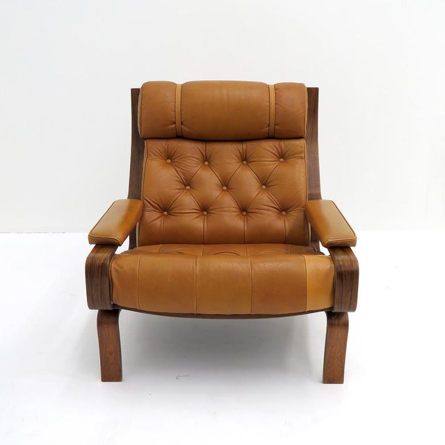 Wonderful leather lounge chair by Pethrus Lindlöf for Lindlöfs Möbler, 1970, with a molded jacaranda frame and upholstered...