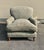 George Smith Standard Arm Style Chair with down seat cushions. The chair sits on turned legs with brass casters. The chair...