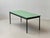 A simple, functional dining table made in switzerland by stein am rhein. The understated design combines a matte green...