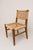 A pair of mid-century French side chairs attributed to Adrien Audoux and Frida Minet, combining solid oak frames with...