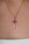 This elegant key pendant features 1.02 carats of natural ruby set in 14K yellow gold. Each ruby measuring approximately...