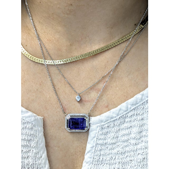 This large tanzanite pendant is a true showstopper—featuring a vivid 8.27-carat center stone surrounded by a shimmering...
