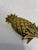 A charming vintage solid brass hook in the shape of a pineapple, with a richly textured fruit, crisp pointed leaves, and a...