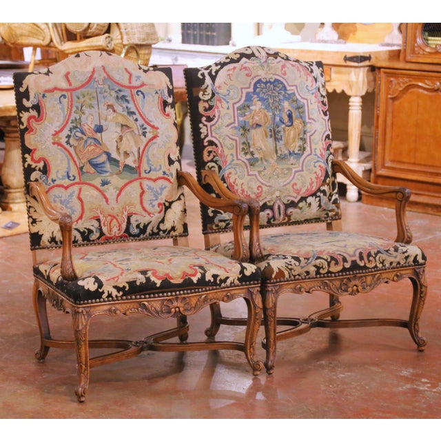 This elegant pair of antique French armchairs was crafted in walnut, circa 1870, and reflects the graceful curves and...