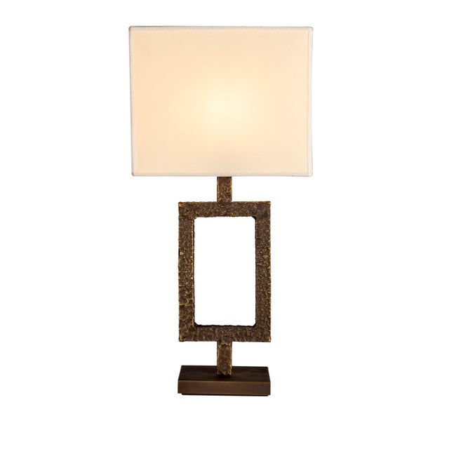 Orion is a table lamp made in Italy with a solid brass base. The base is created through a traditional casting process...