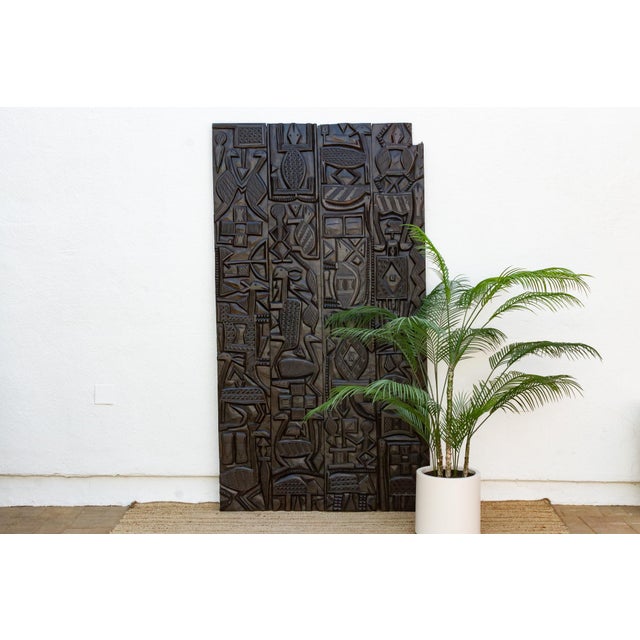Standing nearly seven and a half feet tall, this vintage Nupe door from Nigeria is carved across four vertical planks with...