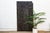 Standing nearly seven and a half feet tall, this vintage Nupe door from Nigeria is carved across four vertical planks with...