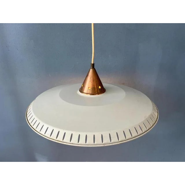 Large metal Louis Kalff Philips pendant lamp with opaline glass inner shade. The piece has a metal, UFO shape with a small...