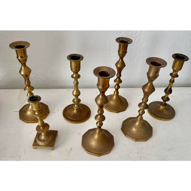 Set of seven vintage aged patina solid brass candlesticks.