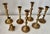 Set of seven vintage aged patina solid brass candlesticks.