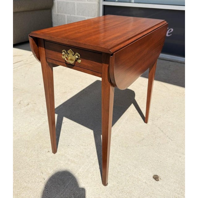 Henkel Harris Solid Cherry Pembroke Drop-Leaf Side Table, Model No. 5406, featuring a rectangular top with gracefully...
