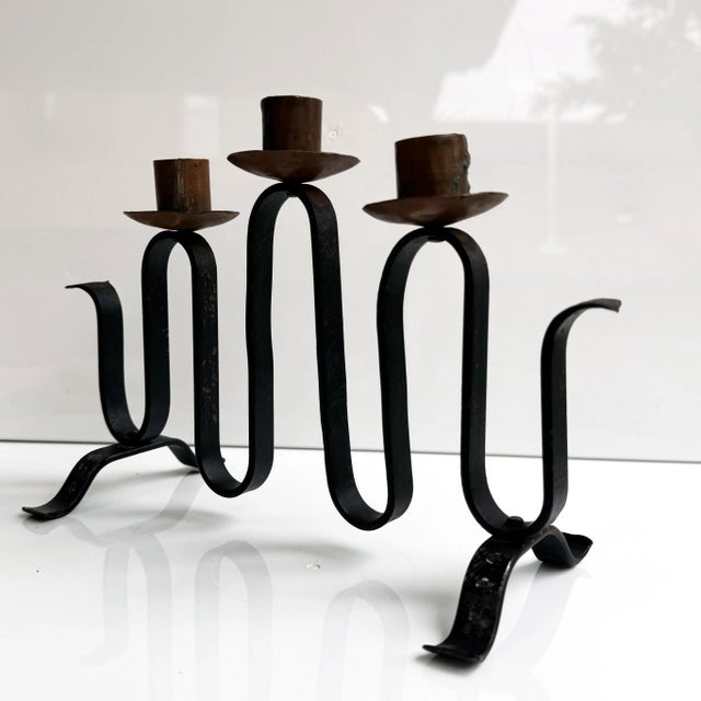 French Modernist Ondulation Candlestick attrib. to Jean Royere. Steel, topped with copper candle votives.