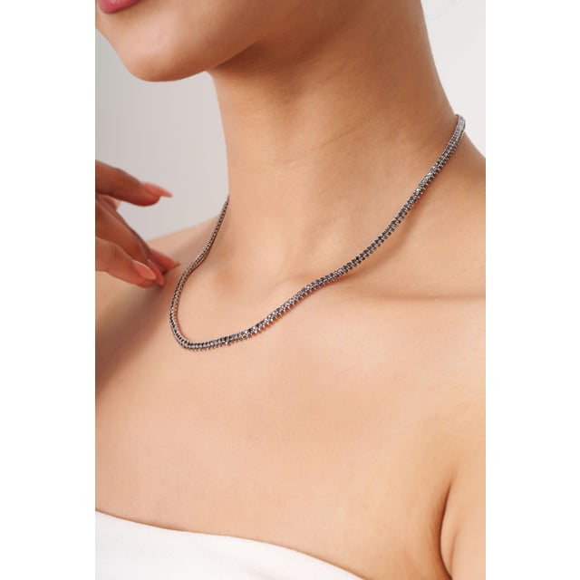 This elegant necklace features a 7.5-carat round black diamond, set in 18k white gold. The diamond sizes are approximately...