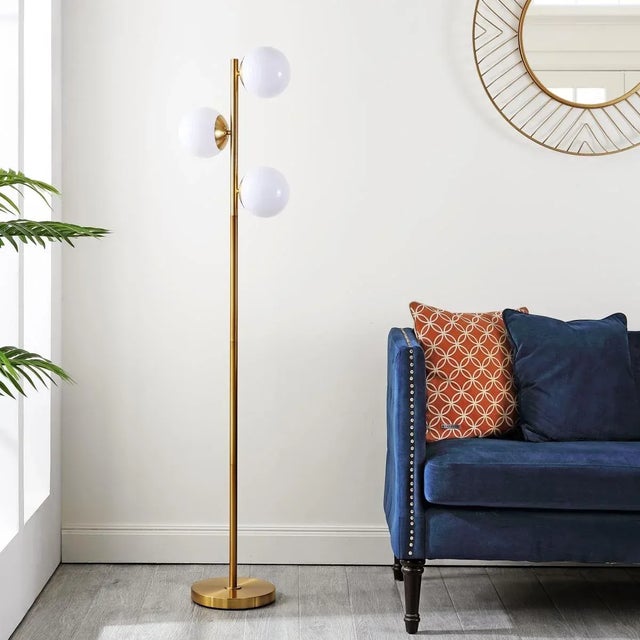 Introducing the Devlyn lamp, a blend of modern design and elegant illumination. Standing at 62 inches, this gold metal...