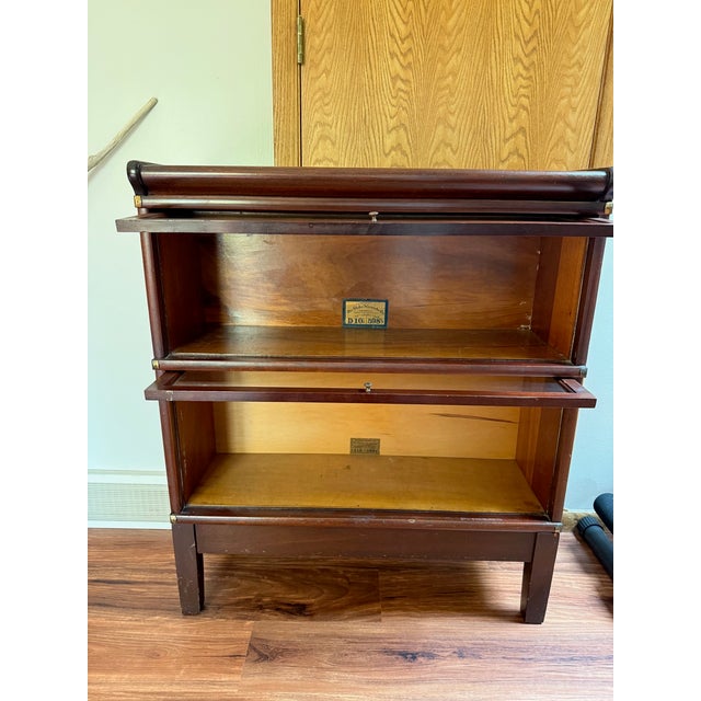 This Globe-Wernicke unit is a high-quality, early 20th-century Mahogany "Ideal" 598 grade bookcase, featuring 598 1/2...
