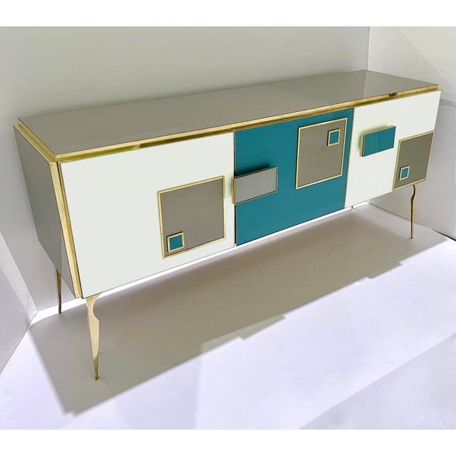 A creative 3-door modern credenza with 2 shelved compartments, entirely handmade in Italy with high-quality details of...