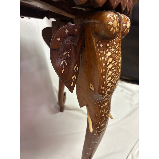 An Anglo-Indian Table of teak or some type of mahogany, extensively inlaid with bone, the round top inlaid with birds,...