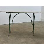 An exceptional French marble-topped garden table with industrial details in the cast iron base reflecting the style of the...