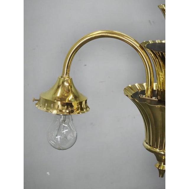 Striking art deco chandelier from 1930s czechoslovakia, crafted from polished brass and fitted with three spherical white...