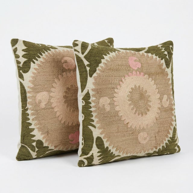 This beautiful 24'' x 25'' hand-embroidered Suzani pillow cover set was made from authentic Uzbek cotton fabric. The...