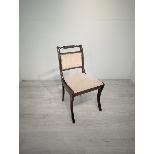 An elegant Empire-style chair, reminiscent of classic European 19th-century design. The chair impresses with its refined,...
