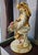Handcrafted ceramic cherub sculpture by Lorenzon, made entirely in Italy. The seated figure features a rich 24K gold...