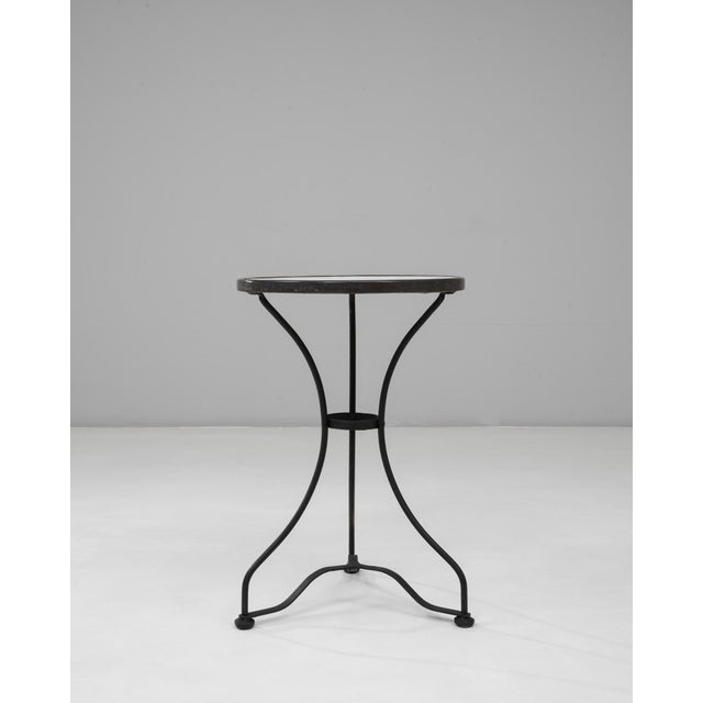 This 1900s French bistro-style iron table with marble top captures the charm and functionality of early café furnishings....