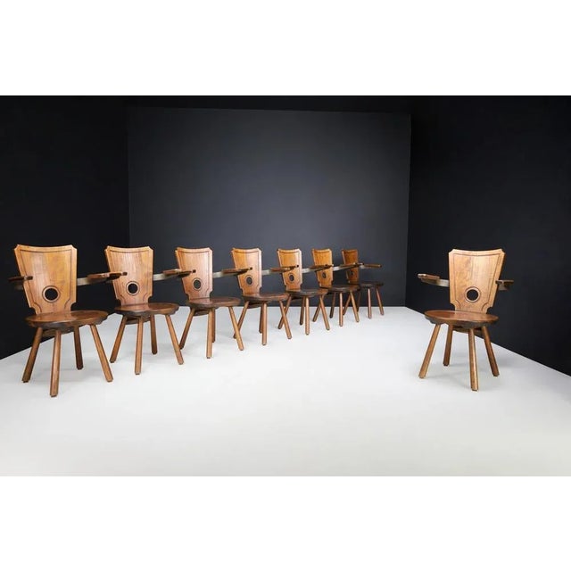This exceptional set of eight French dining chairs from the 1960s captures the essence of mid-century modernism with a...