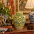 A vintage porcelain ginger jar, hand decorated with green vines and flowers on a yellow field. Good condition.