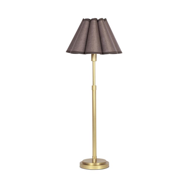 The Polly Buffet Table Lamp showcases sophistication with its single scalloped shade, casting a warm and inviting glow...