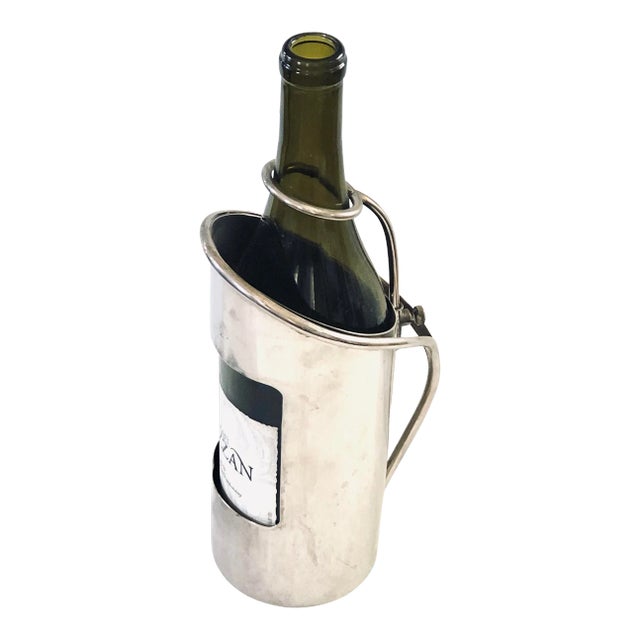 Display your vintage of wine to your guests in this elegant silver wine caddy. The neck is held secure in place with an...