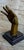 A dramatic solid bronze surrealist hand sculpture, signed by the artist and mounted on a polished black marble base. This...