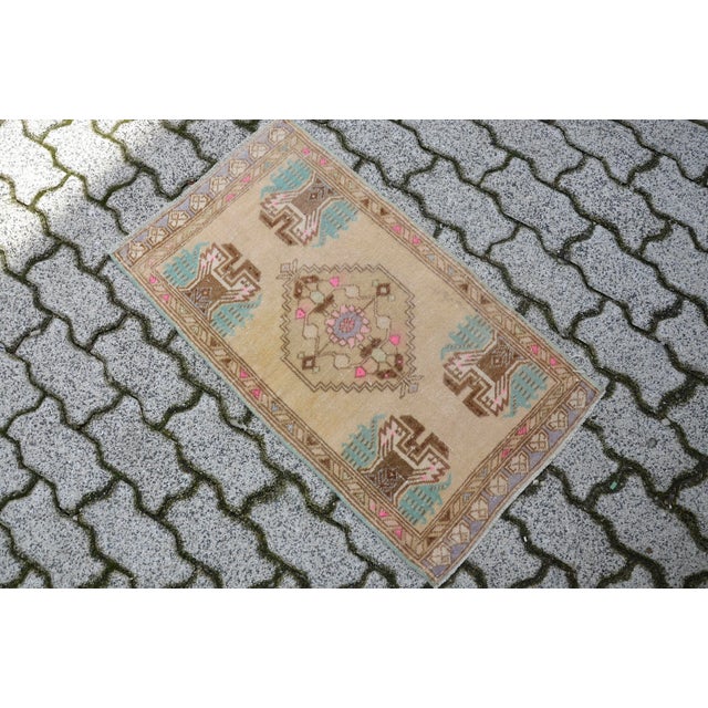 This is a vintage Turkish Oushak rug from the 1960s. The piece was hand-knotted.