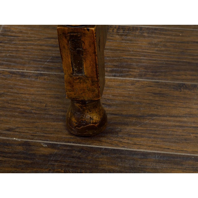 An Italian walnut console table from the 19th century with column shaped legs and iron stretchers. This Italian walnut...