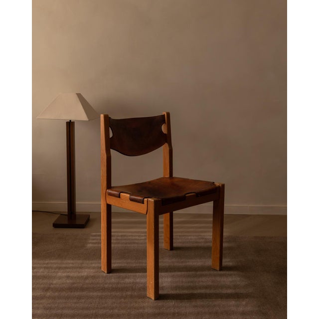 Vintage Maison Regain pine and leather chair, France, 1970s. The design combines a solid elm frame with a floating saddle-...