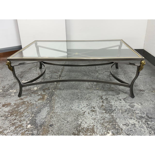 Design Plus Gallery presents a 1980's Hollywood Regency Glass Top Lion Coffee Table. This coffee table has a rectangular...