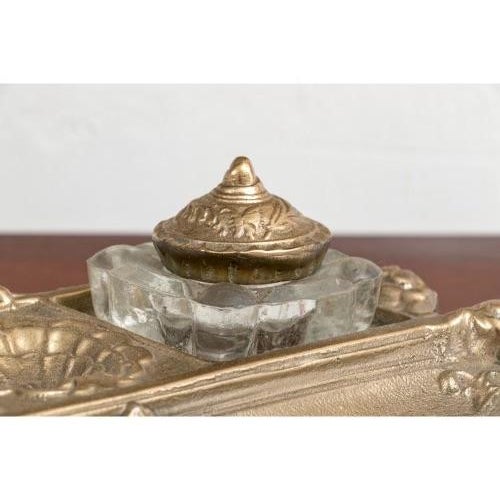 A vintage ornate Rococò style brass double inkwells with two crystal inkwells with decorative lidded tops, a small shell-...