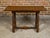An Italian Baroque style walnut side table from circa 1800 with spool legs, H-Form cross stretcher and bun feet. This...