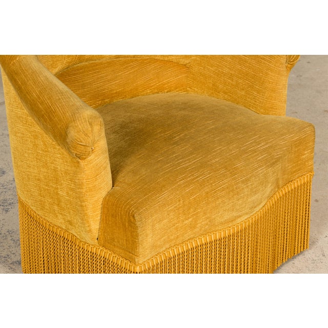 An elegant French mid-20th century Napoleon III style crapaud armchair, sourced in Provence, France. The chair presents...