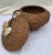 Vintage cone shaped reed and rattan hand woven basket. Two seashells adorn the lid which is tethered to a third seashell...