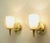 Pair of brass double hurricane sconces by Gerald Thurston for Lightolier. Each solid brass sconce has a double hurricane...
