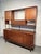 Distinctive sideboard manufactured by Stanley, featuring a sleek mid-century profile with an attached upper cabinet...
