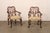 An English pair of wooden armchairs, with richly carved decorative details and elegant proportions, from the early 20th...