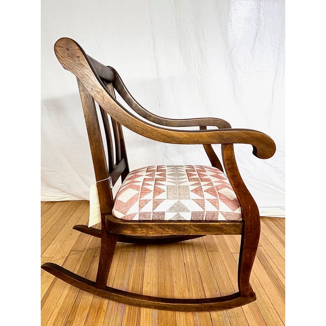Classic vintage Empire style parlor rocking chair crafted in oak with a walnut finish. Made in the United States in the...