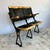 Pair of cinema seats featuring cast iron frames, bentwood construction, and folding mechanism with original hat stows...