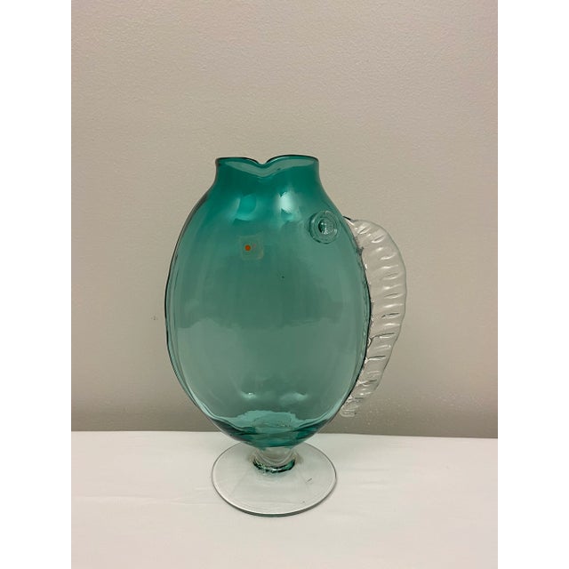 A vintage Blenko hand-blown glass flower vase in the shape of a fish. Excellent vintage unused condition and bears the...