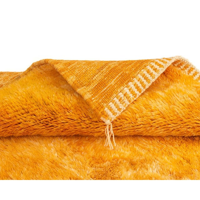 A sunset captured in wool — warm, painterly, and quietly striking. This hand-knotted Moroccan rug renders an abstract...