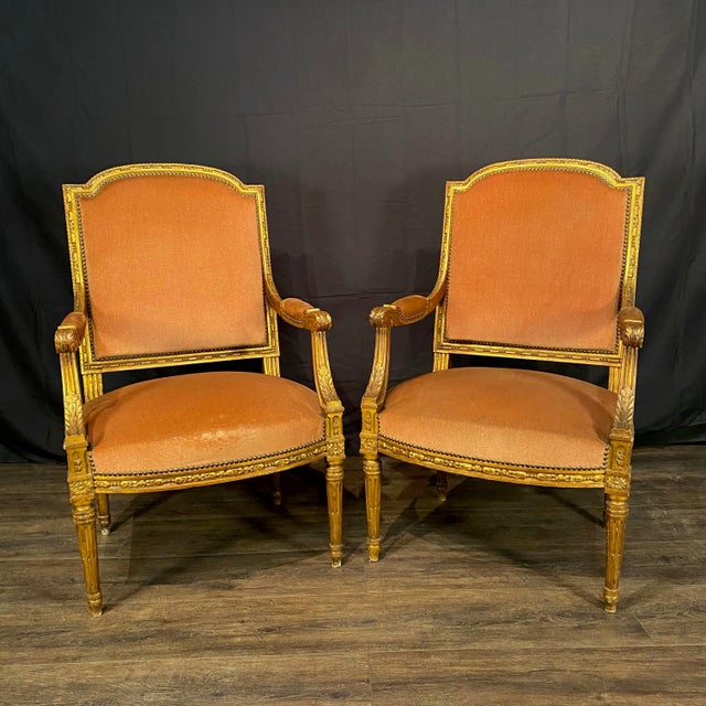 Pair of elegant antique French Louis XVI armchairs from the Napoleon III Belle Epoque era crafted with finely carved...