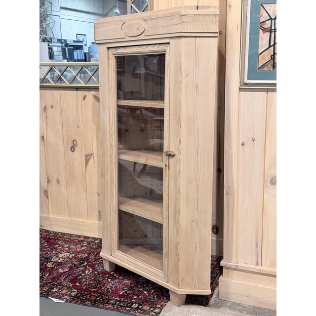 A beautifully crafted corner display cabinet executed in warm natural pine. Designed to maximize space while maintaining...