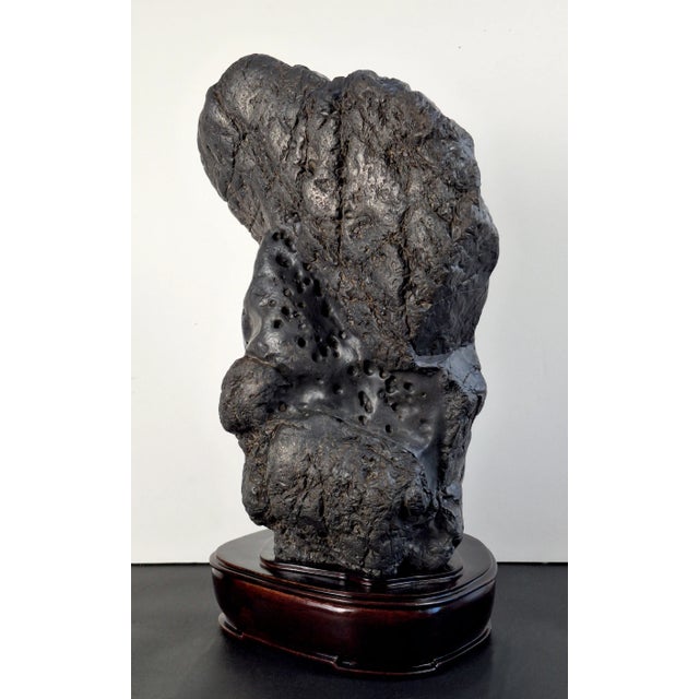 Large Chinese thundercloud gongshi, a large, heavy, pyroclastic, dark grey, viewing stone, with a waxy finish, that has...